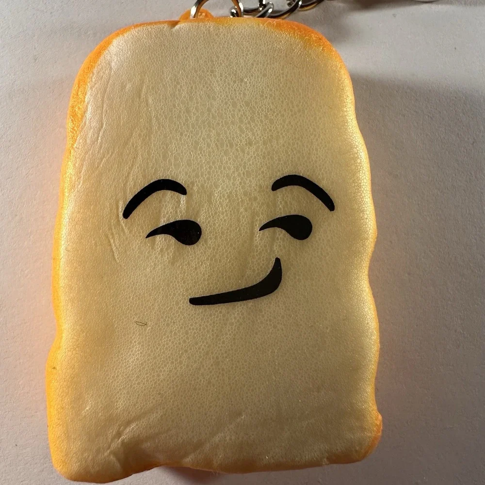 Cute Slice of toast keychain featuring playful smug facial expression